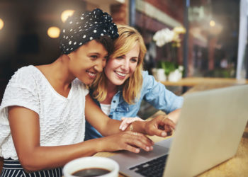 two women looking at computer